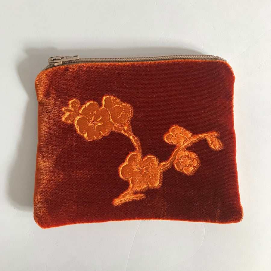 Orange small pouch purse with floral embossed velvet and linen design.    