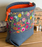 Drawstring project bag made with bright floral print in grey and orange - Image 3