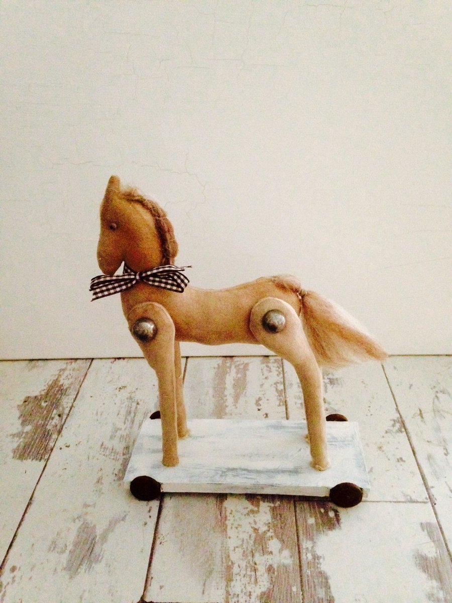 Fabric horse on wooden ornamental wheeled base
