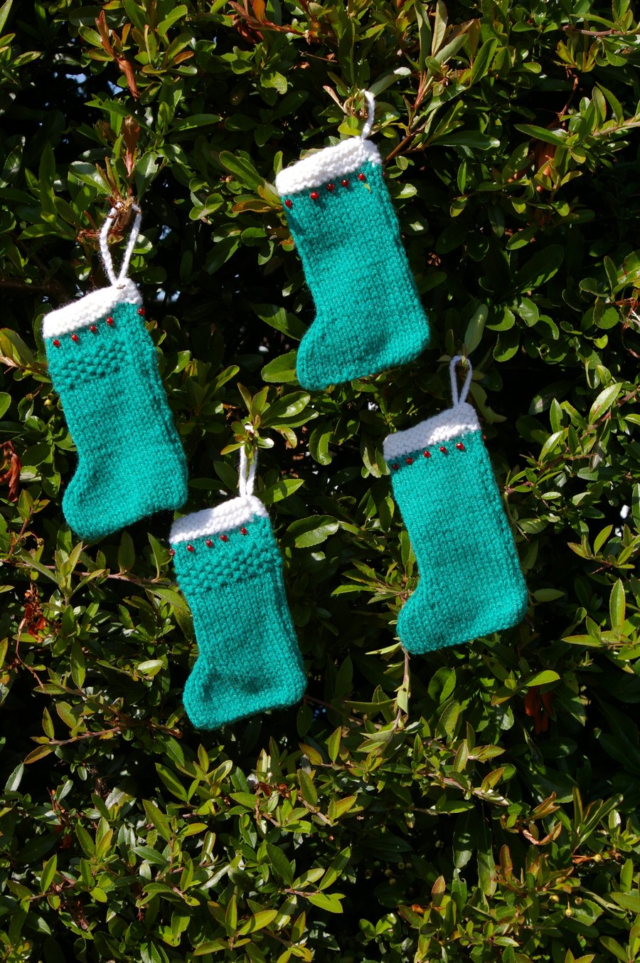 Four Christmas Stocking Decorations knitted in Green