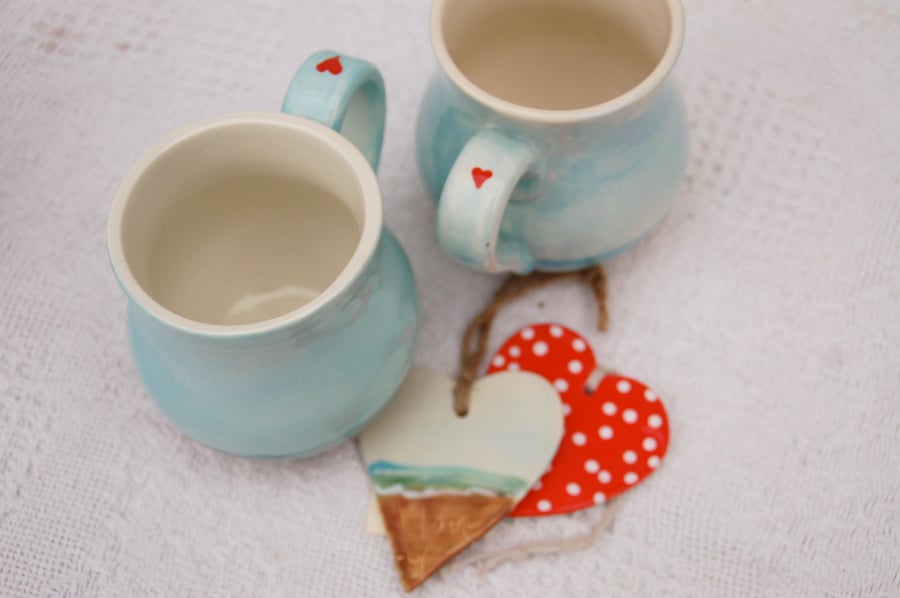 Two valentine mugs, beach