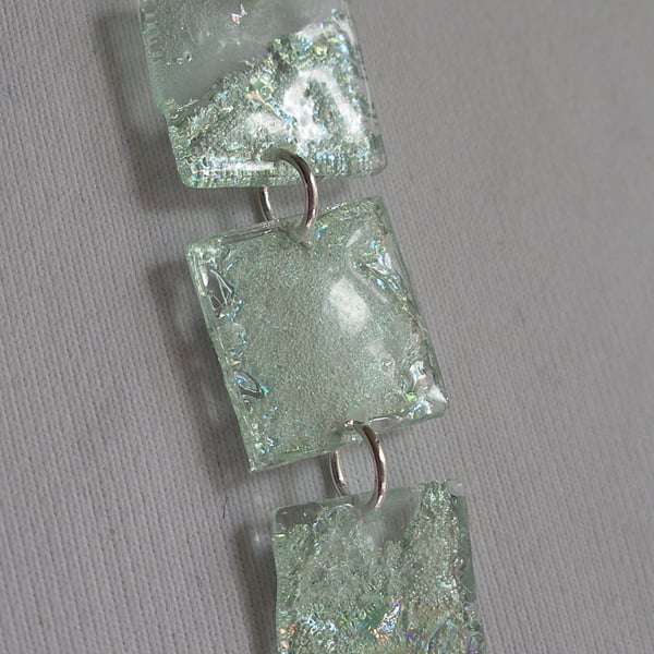 Three piece pale green pendant.