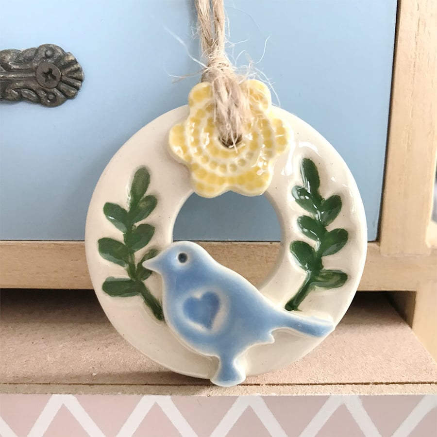 Teeny bird and flower wreath pottery decoration