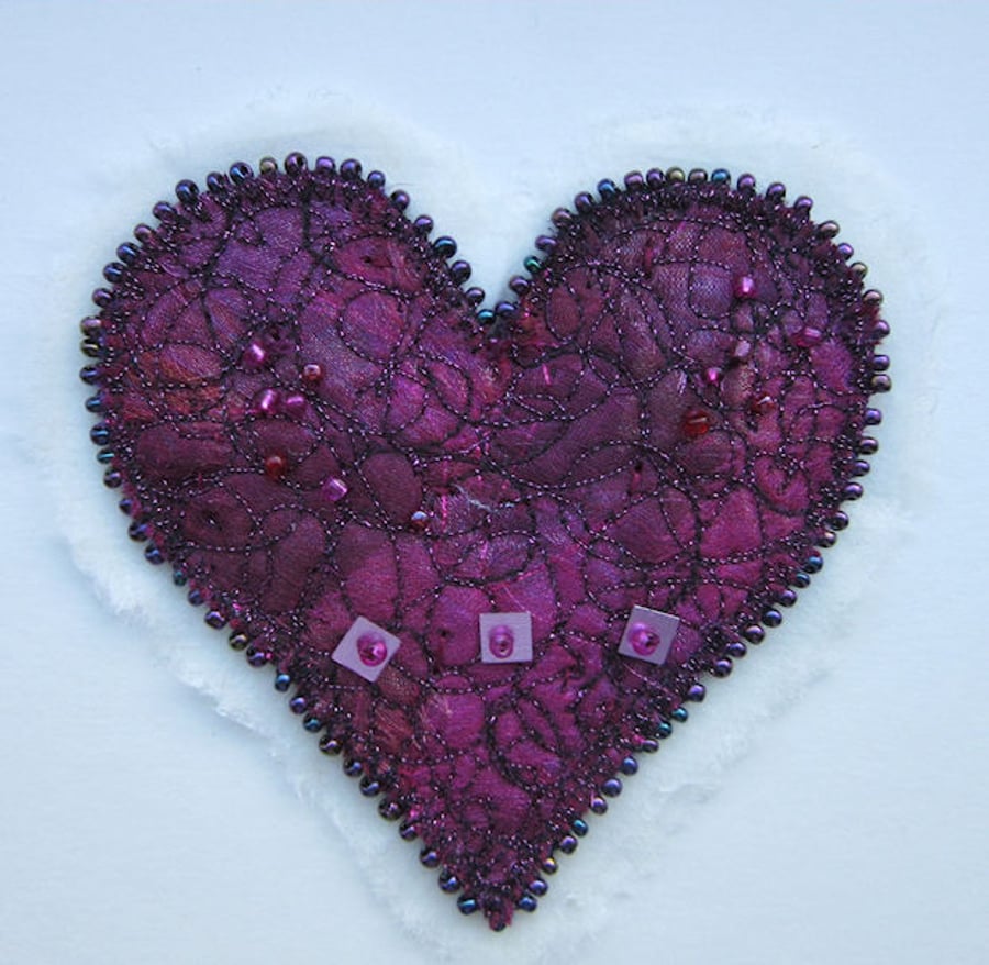 HEART PICTURE.  Dark pink and maroon beaded and stitched textile heart