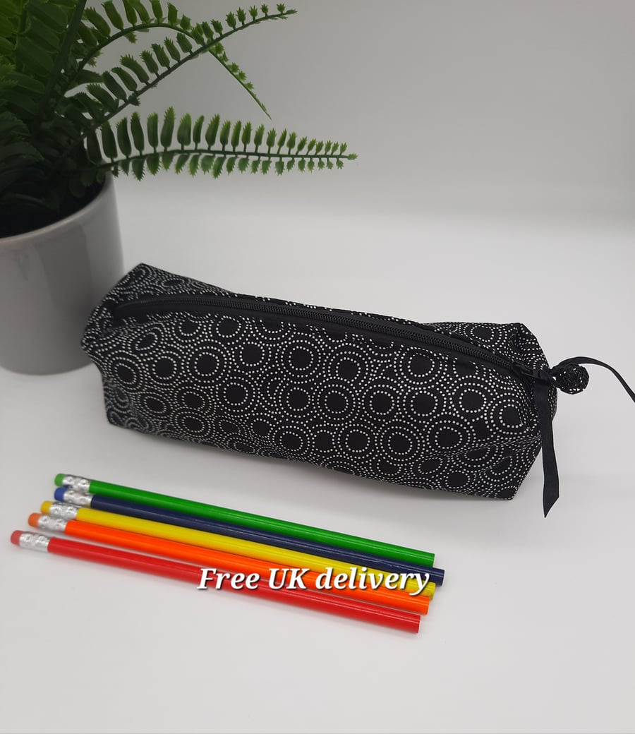 Pencil case in black and white pointillism circular pattern.  