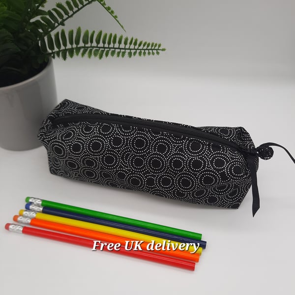 Pencil case in black and white pointillism circular pattern.  