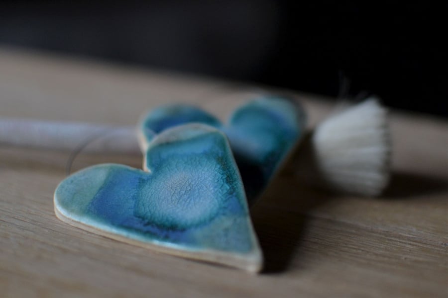 Ceramics heart glazed in blues and turquoise designed to hang on the wall