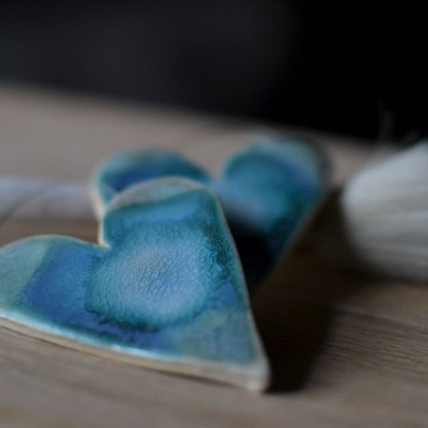Ceramics heart glazed in blues and turquoise designed to hang on the wall
