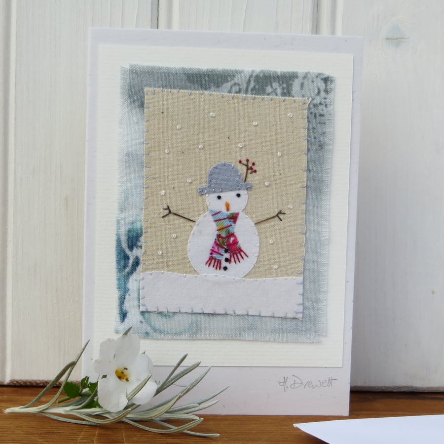Sweet little snowman card with wintry background and berries in his hat!
