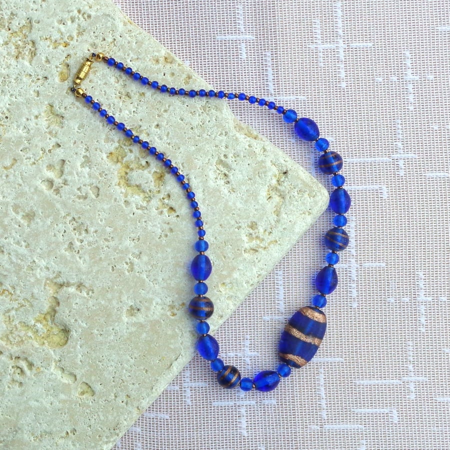 Necklace of mixed glass beads in deep blue & old gold