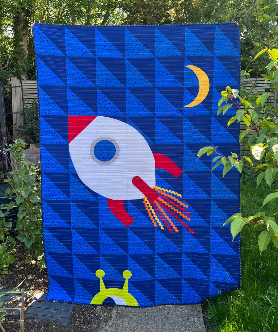 Colourful space-themed single featuring a rocket and a cheeky alien