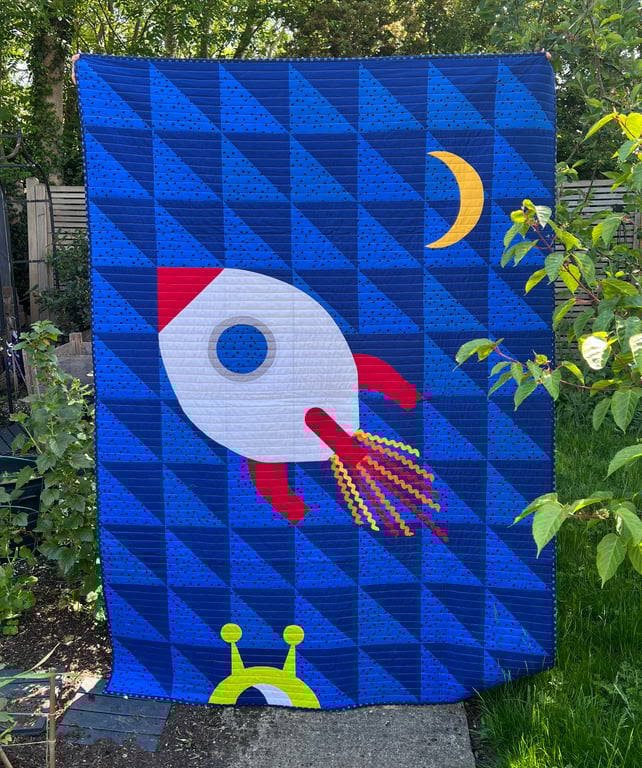 Colourful space-themed single featuring a rocket and a cheeky alien