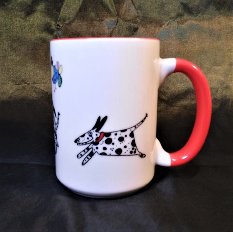 A large ceramic mug hand decorated with Dalmatians and two amusing birds. It has