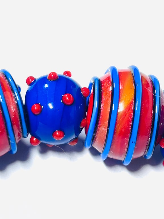 Handmade orange and blue lamp work glass beads