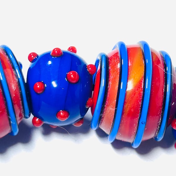 Handmade orange and blue lamp work glass beads