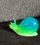 Handmade epoxy resin snail ornament. Glow in the dark!