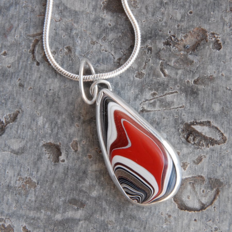 Small red fordite and silver pendant