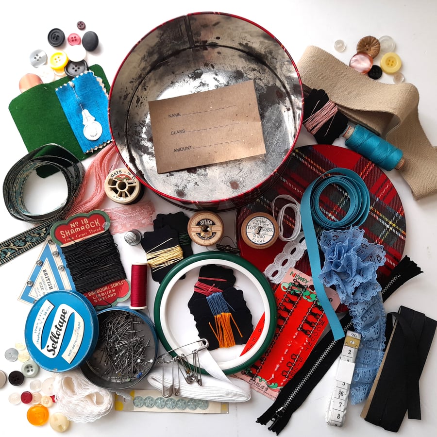 Vintage sewing haberdashery kit in an old tartan biscuit tin