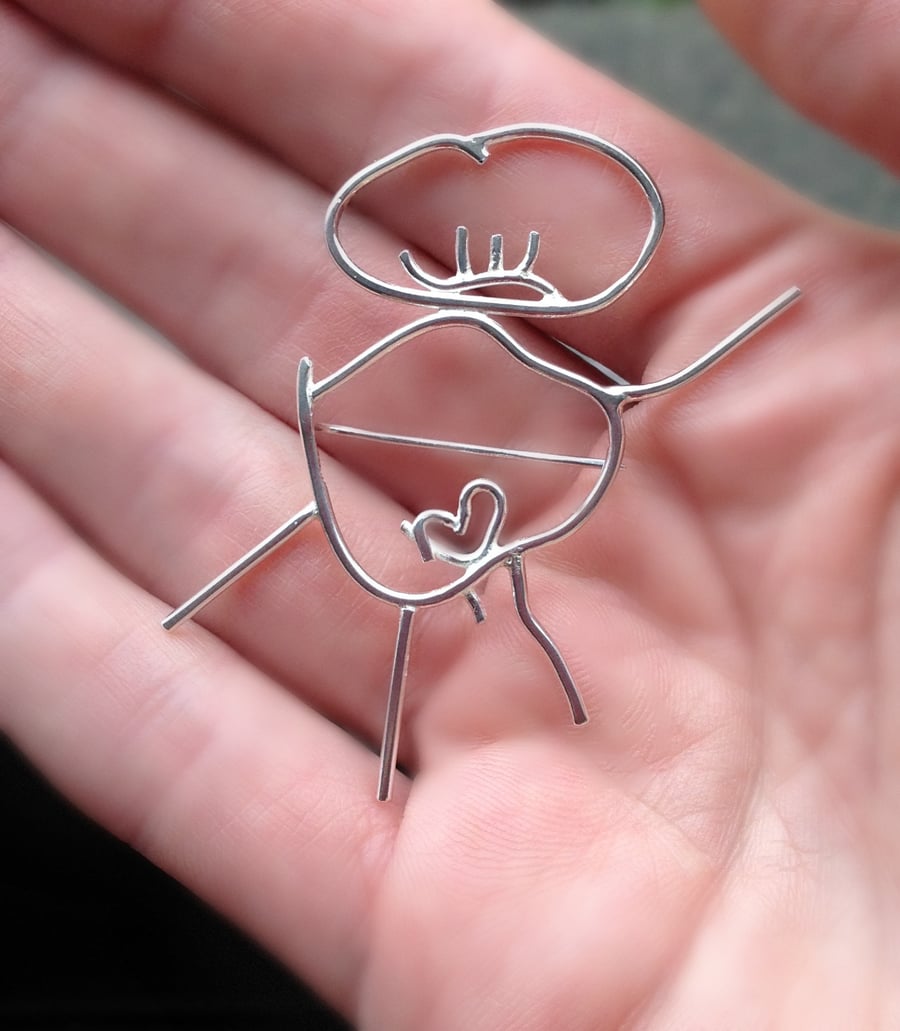 A sterling silver brooch from a childs first drawing