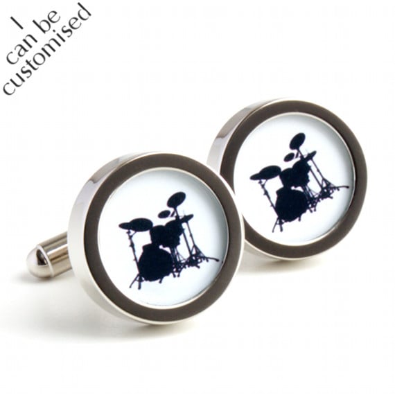 Drum kit cufflinks with a black drum set silhouetted on a white background. Choo