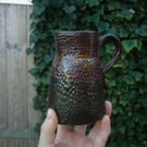 Rustic black and crimson small ceramic jug or vase 