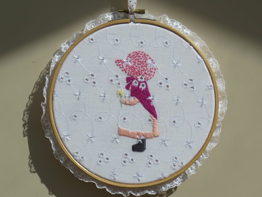 Hoop embroidery of a girl in pink