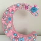 Pink standing letter C