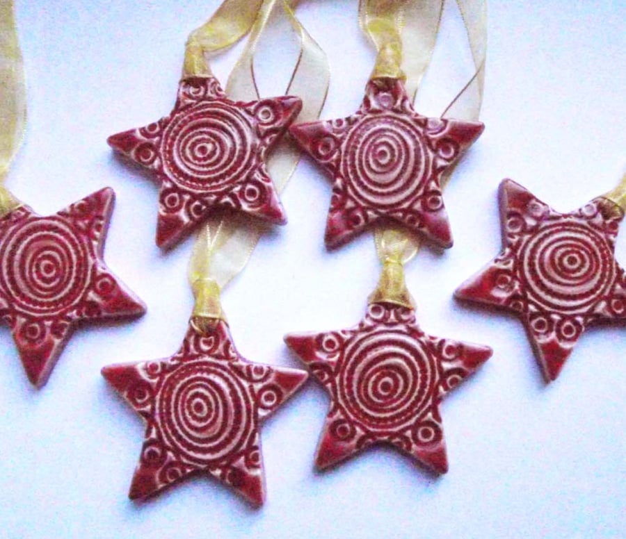 Set of six little red handmade ceramic star decorations