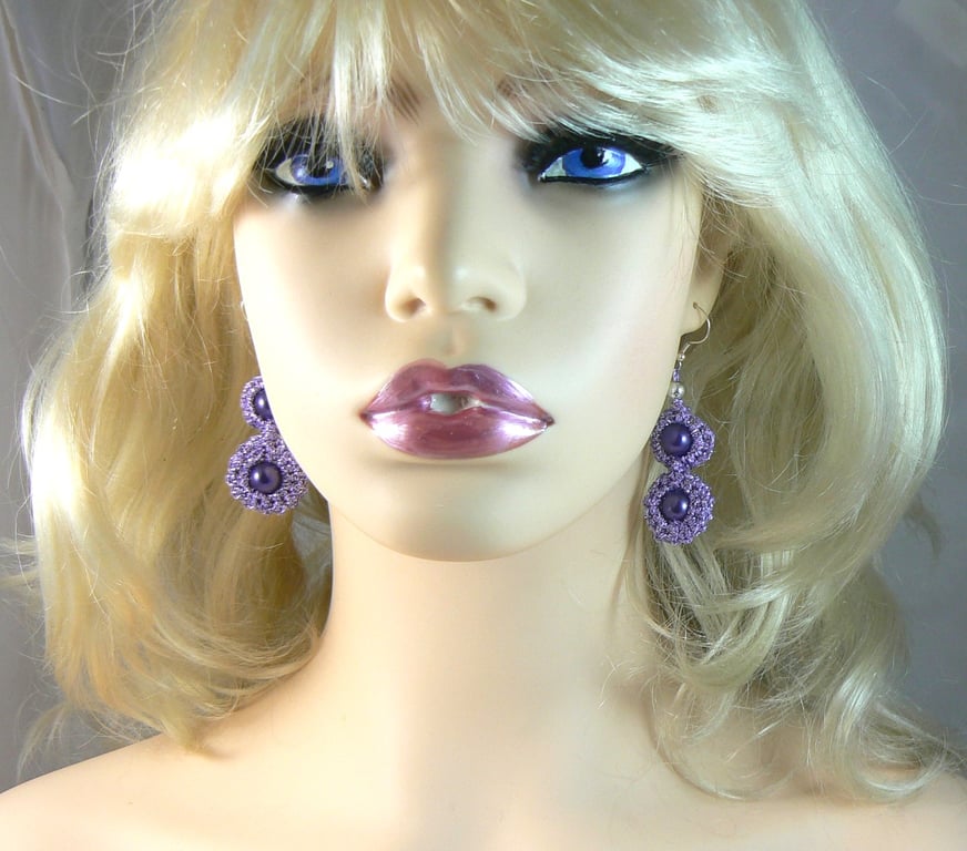 Crocheted lilac flower earrings with purple beads.