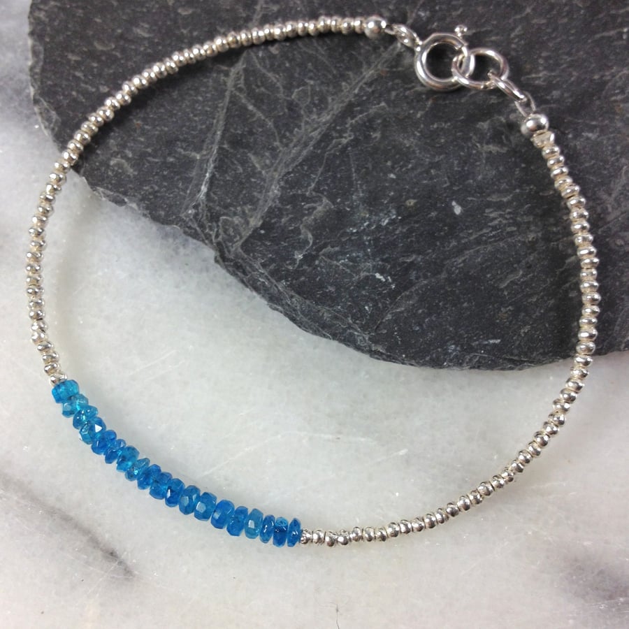 Silver friendship bracelet with faceted blue apatite gemstones