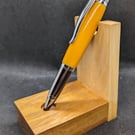 A rollerball pen in vibrant orange