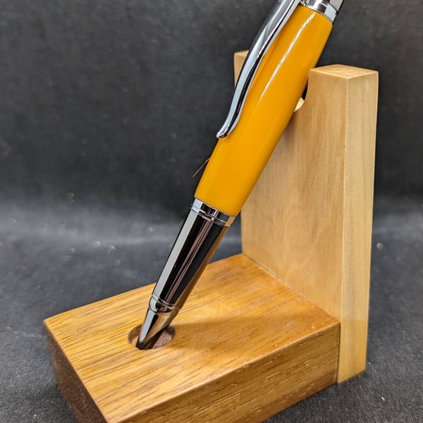 A rollerball pen in vibrant orange