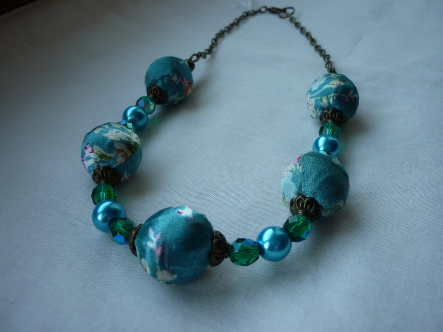 TURQUOISE SATIN KIMONO DESIGN BEAD NECKLACE.  235