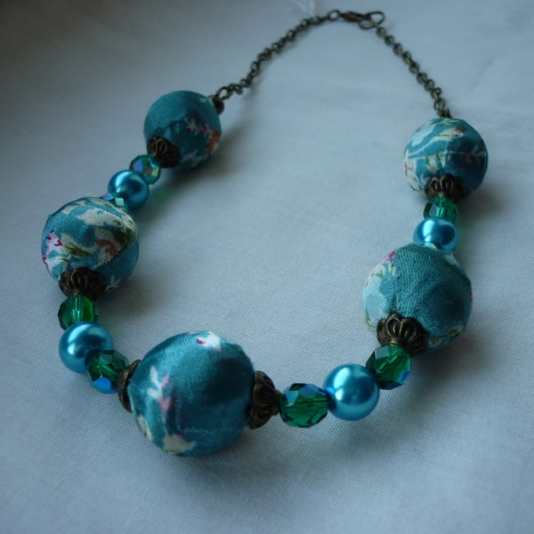 TURQUOISE SATIN KIMONO DESIGN BEAD NECKLACE.  235