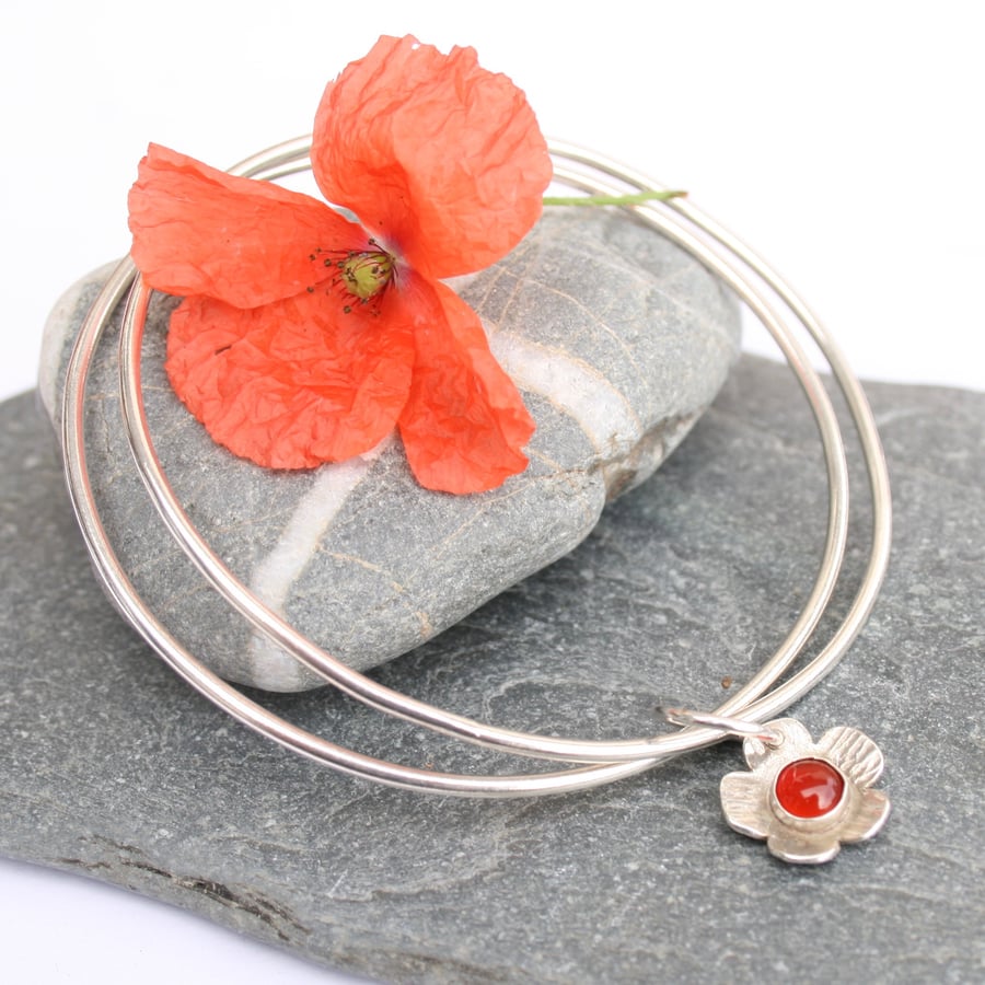 Sterling silver bangle with flower charm
