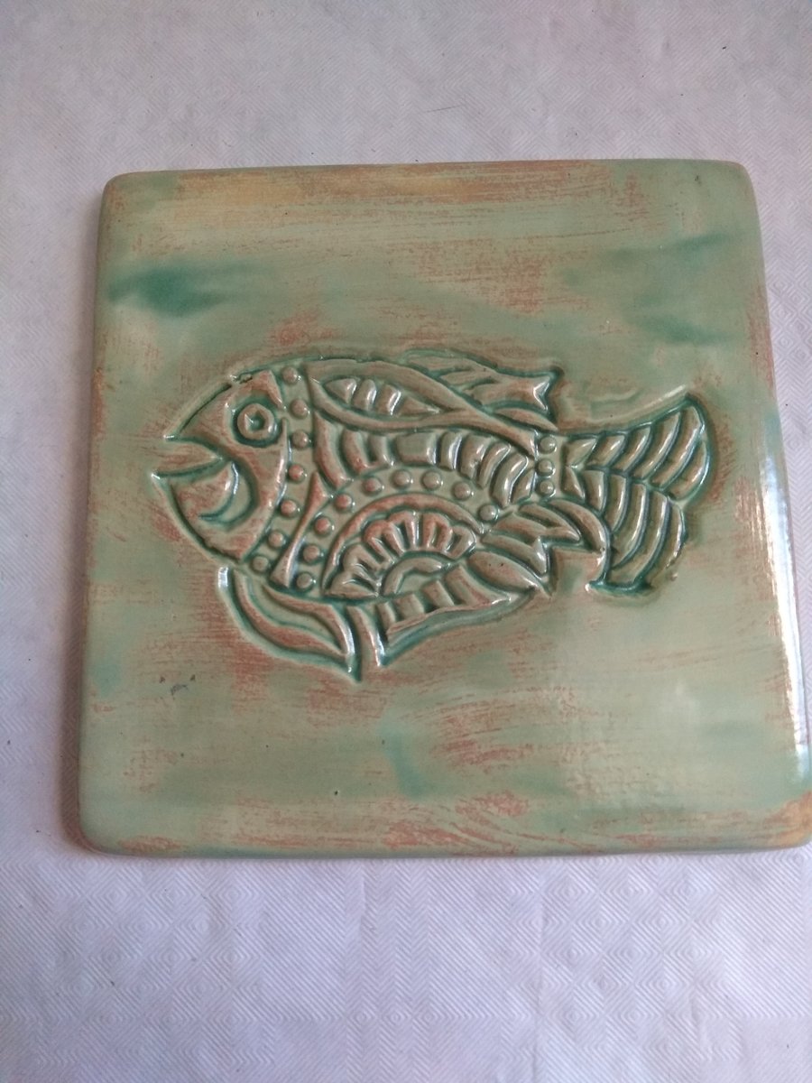 POTTERY COASTER, TURQUOISE GREEN WITH FISH DESIGN  10 CMS X 10 CMS