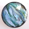 brooch - round: shades of green and blue, hints of yellow and red