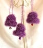3 purple hand knitted jingle bells