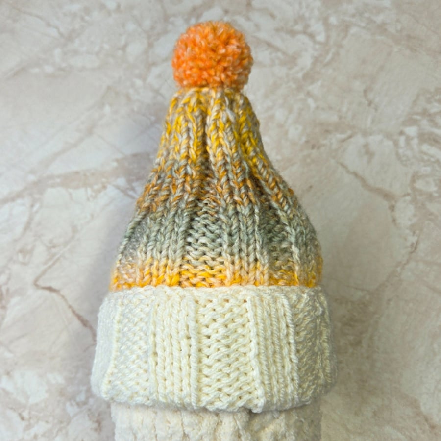 Handknitted child two tone bobble hat