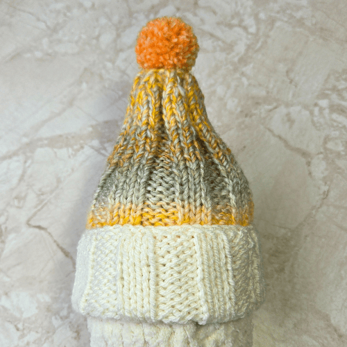 Handknitted child two tone bobble hat