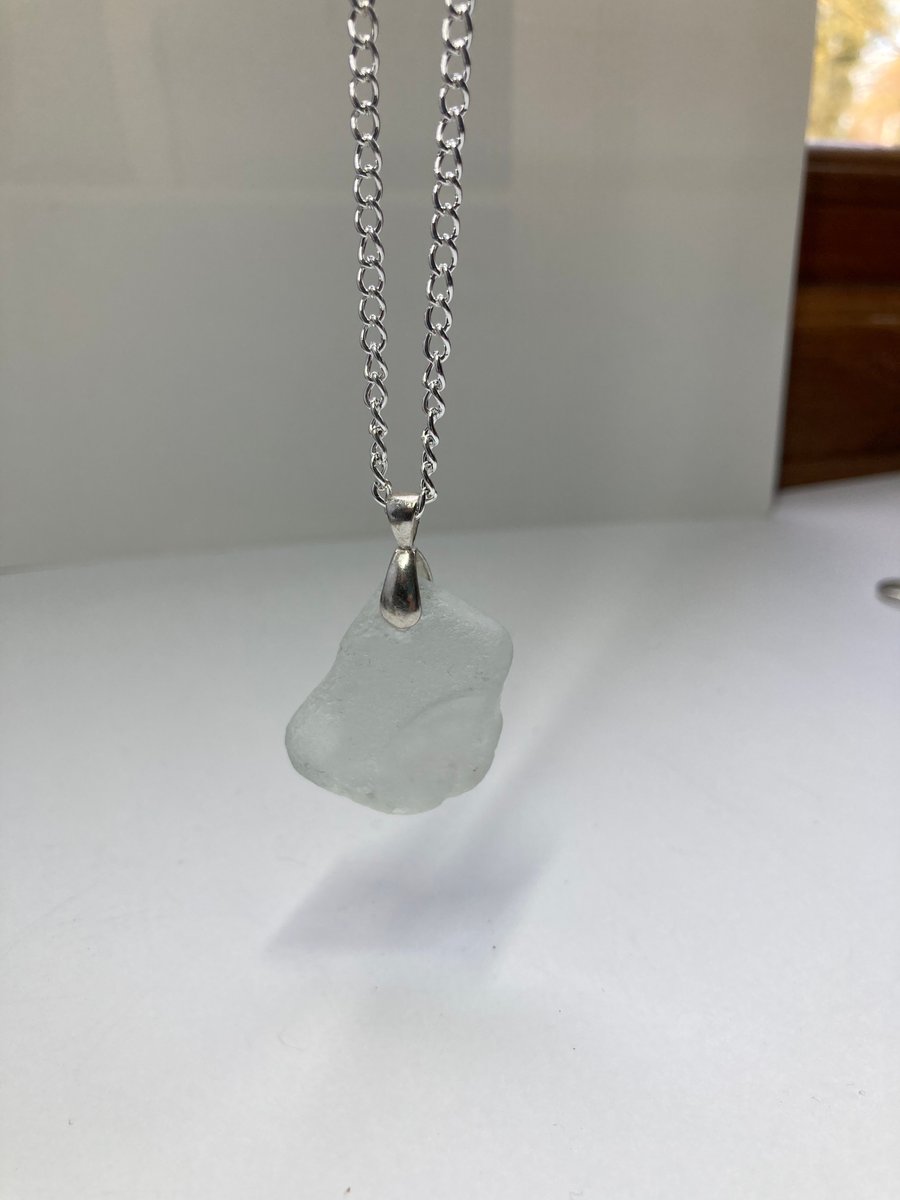 White sea glass pendant with silver plate mount and chain