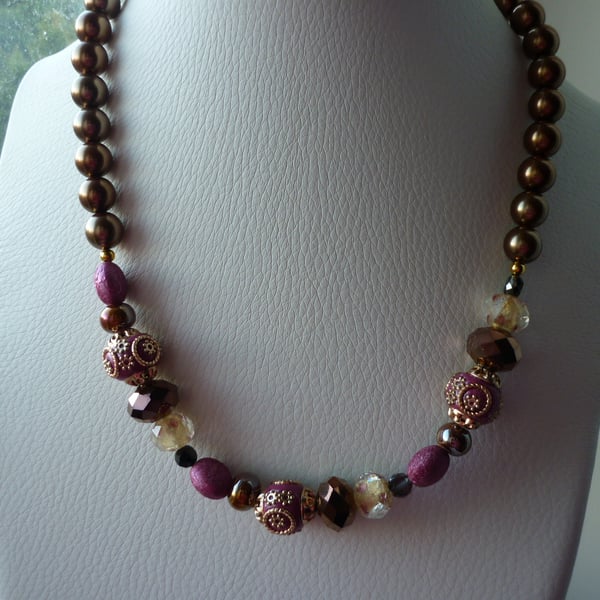 PINK, BRONZE, IVORY AND GOLD NECKLACE.