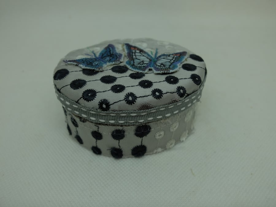 Small oval fabric covered gift box with blue butterflies