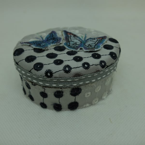 Small oval fabric covered gift box with blue butterflies