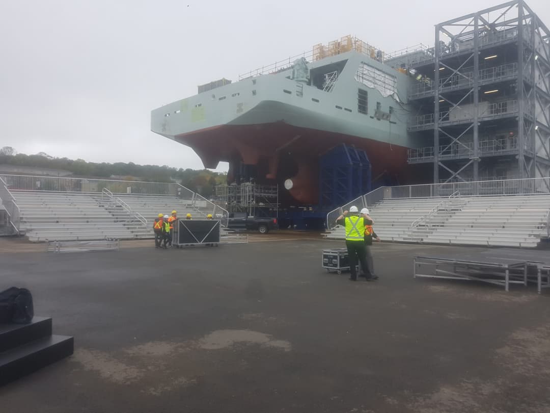 Crew inspecting bleacher guardrails