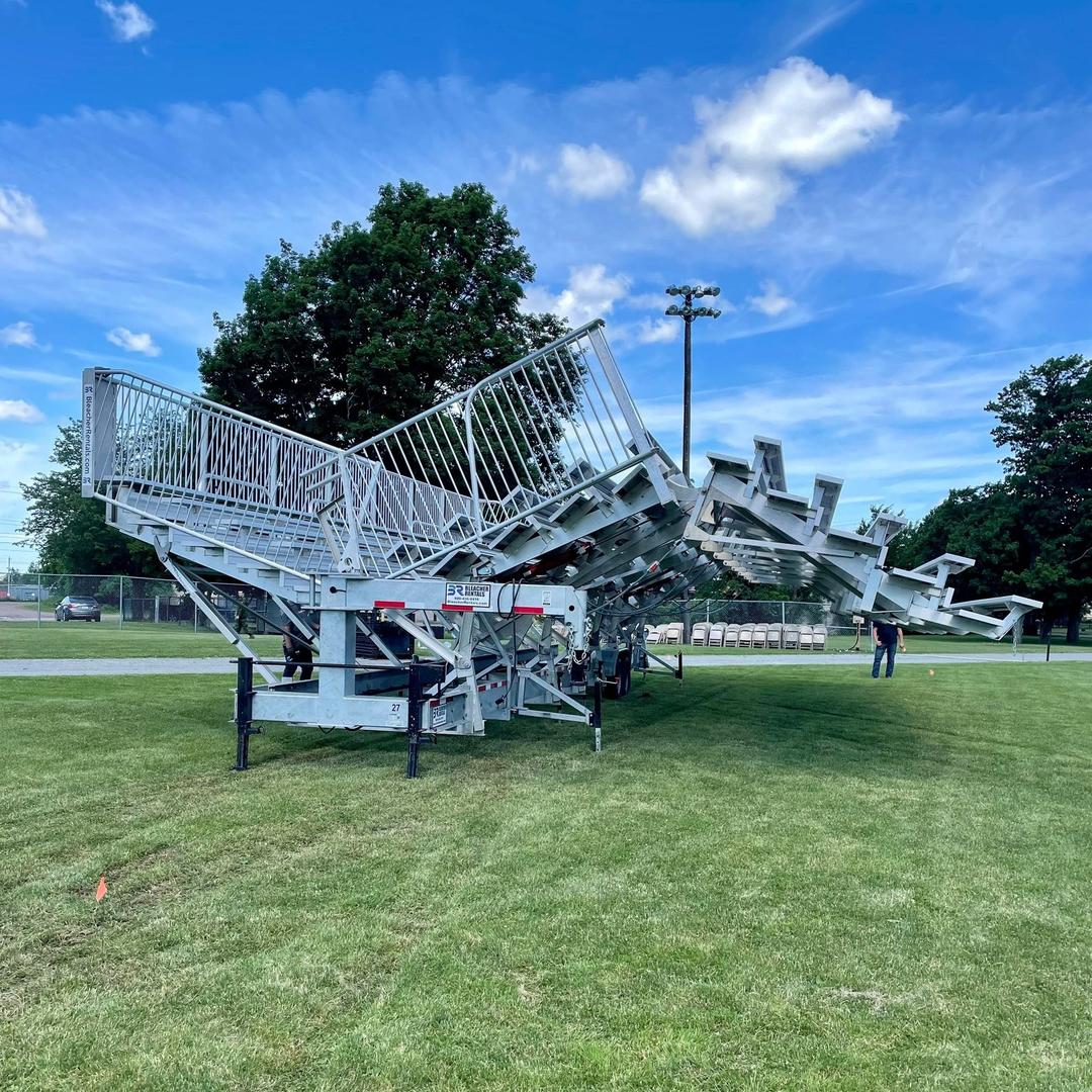 Crew setting up mobile bleachers