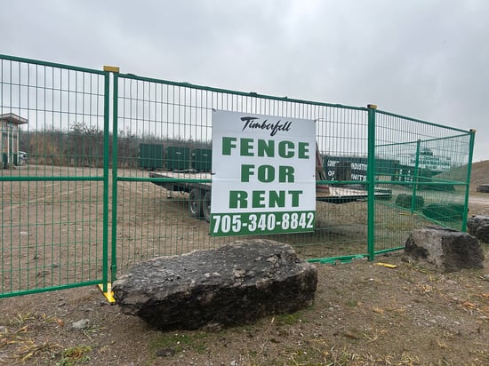 Green temporary fence panels installed around a work area