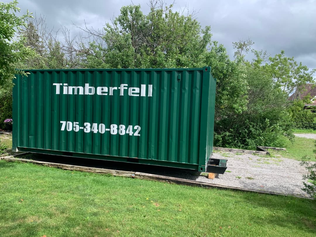 Green 8x20 Timberfell sea can set on timber blocking at a customer property