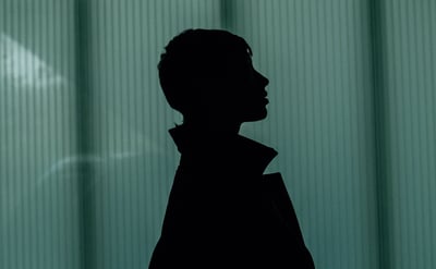 Silhouette Profile Against Ribbed Teal Background