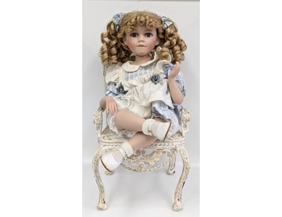 PORCELAIN DOLL WITH ORNATE WICKER CHAIR

Item Si...